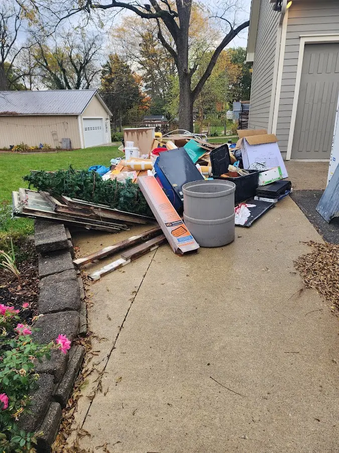 Dumpster being loaded with debris for 30 Yard Dumpster Rental in Tri-City
